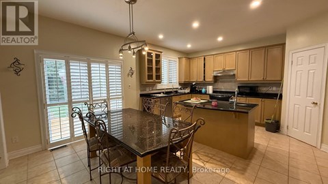 A kitchen with a table and chairs in the middle of the room.