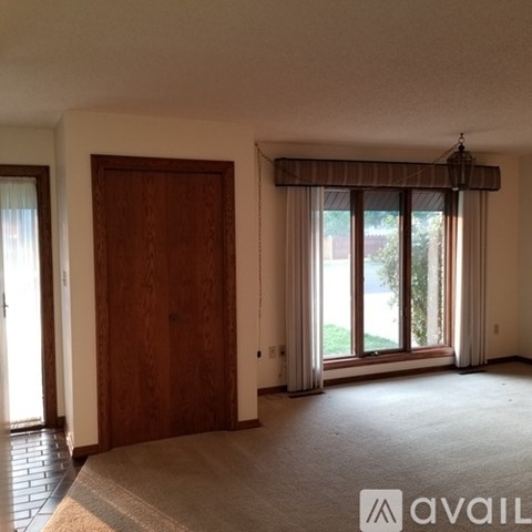 A room with a large window and a door.