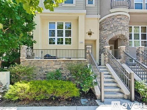 A house with a stone pillar and a staircase leading to the entrance.