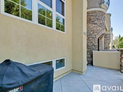 A patio area with a stone pillar and a stone staircase.
