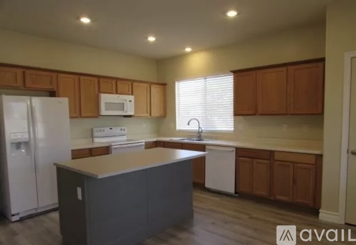 A kitchen with wooden cabinets and a white fridge.
