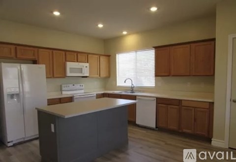 A kitchen with wooden cabinets and a white fridge.