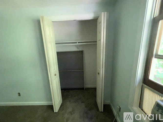 A room with a white door and a window.