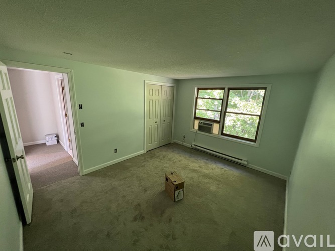 A room with a window and a door is available for rent.