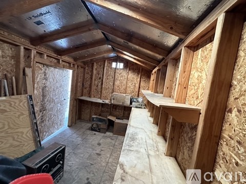 A room under construction with wooden walls and ceiling.