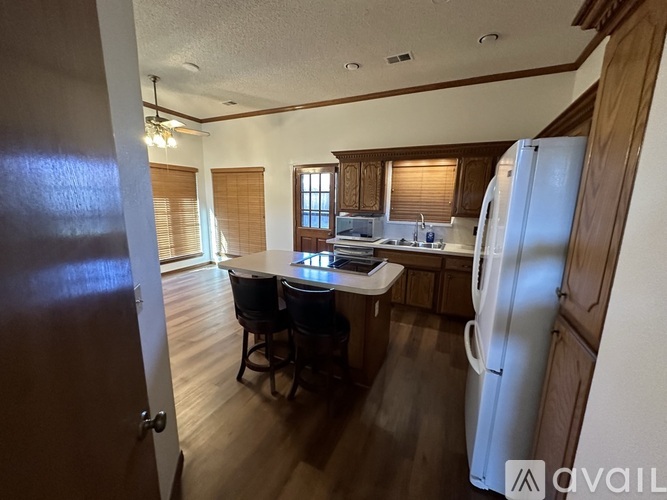 A kitchen with a table and chairs in the middle of the room.