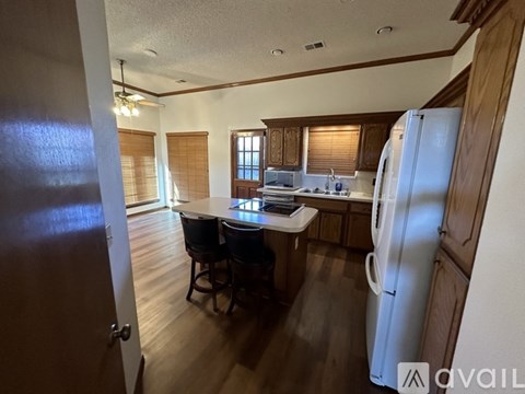 A kitchen with a table and chairs in the middle of the room.