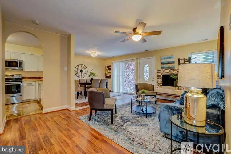 A living room with a couch, chairs, and a coffee table.