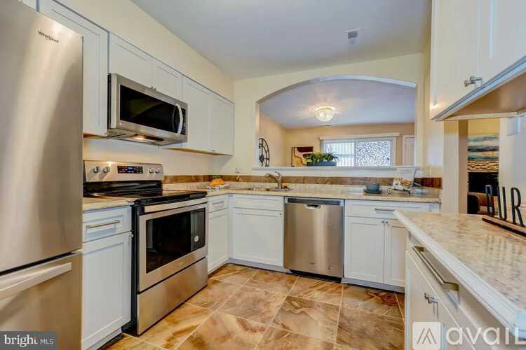 A kitchen with white cabinets and stainless steel appliances.