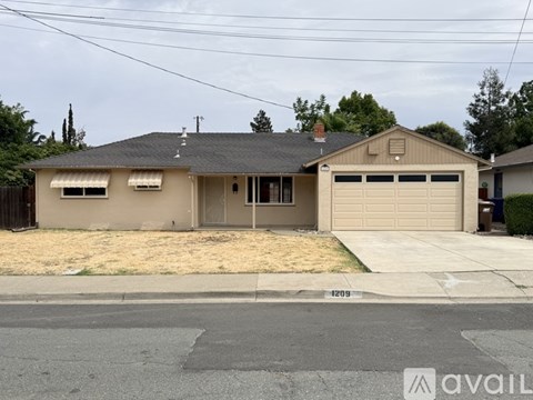 A two-story house with a garage is for sale.