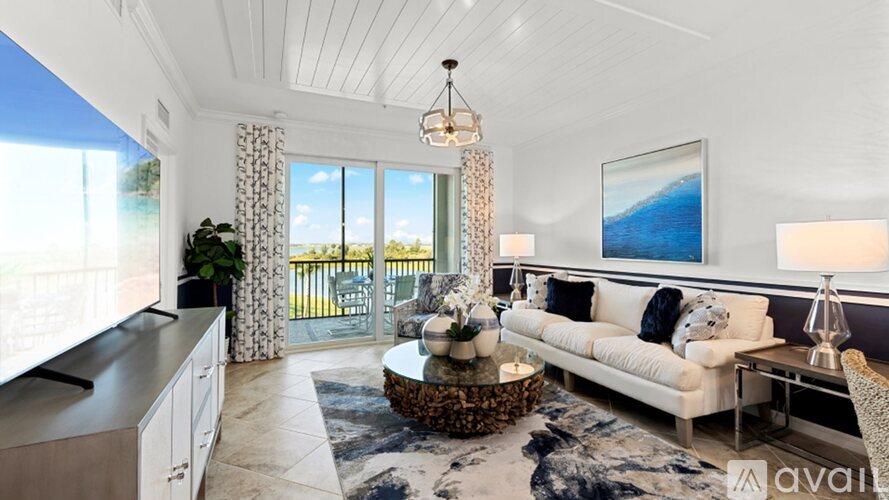 A living room with a white couch and a coffee table.