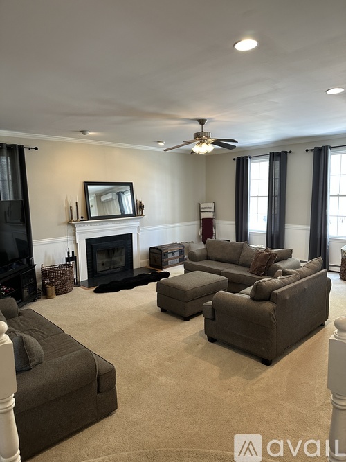 A living room with a fireplace and a television.