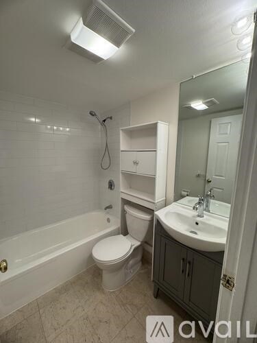 A bathroom with a toilet, sink, and bathtub.