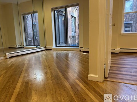 A room with wooden floors and a large window.