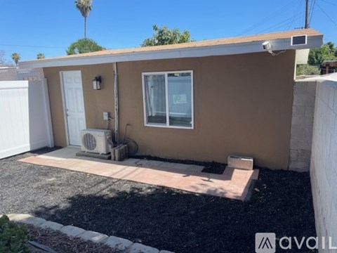 A small house with a brown exterior and a white door is available for rent.