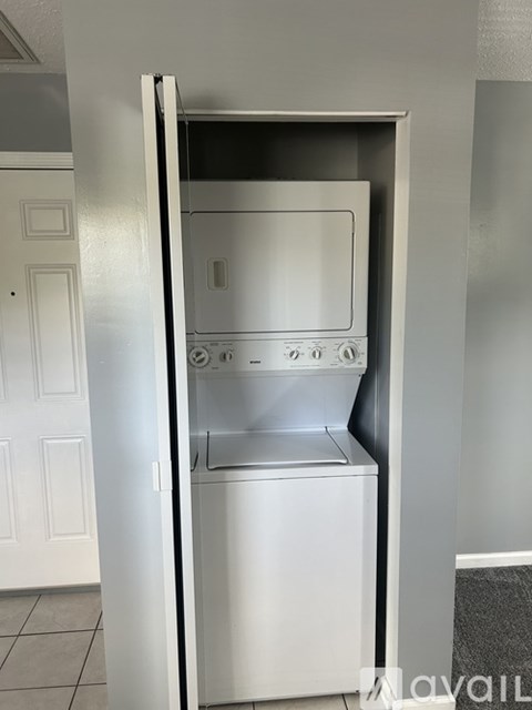 A white oven with the door open in a kitchen.