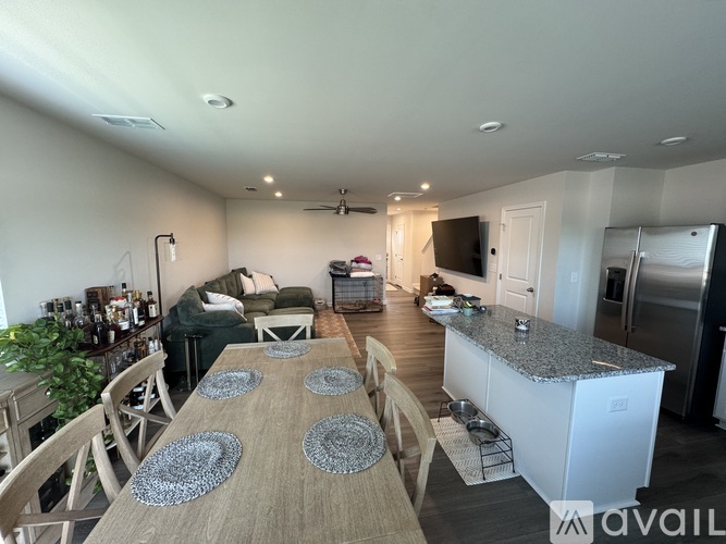 A modern kitchen with a dining table set for four.