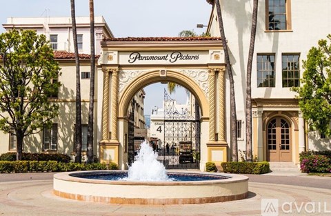 A fountain in front of a building entrance with the sign "Paramount Pictures" above it.