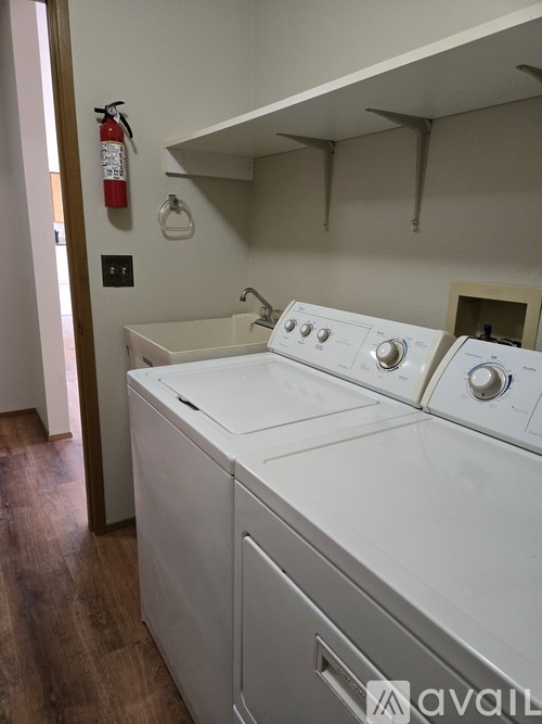 A white washing machine and dryer in a laundry room.