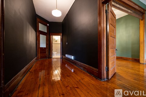A room with wooden floors and a large open door.