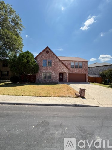 A house with a red brick exterior and a brown garage door.