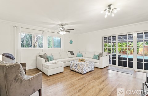 A living room with a grey chair and a white sofa.