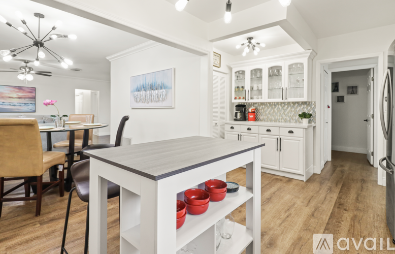 A kitchen with a dining table and chairs.