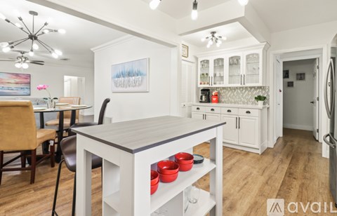 A kitchen with a dining table and chairs.