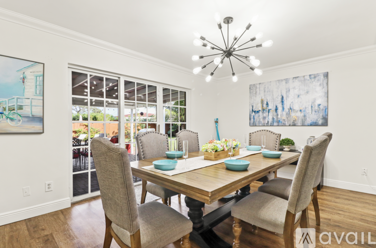 A dining room with a wooden table and chairs.