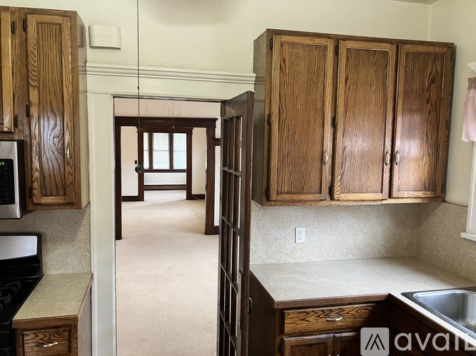 A kitchen with wooden cabinets and a sink.