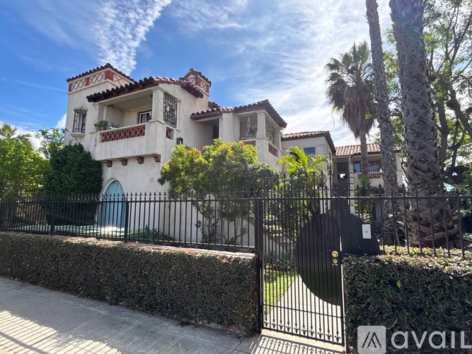 A house with a blue door and a black fence.