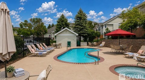 A pool with a slide and a hot tub in a backyard.