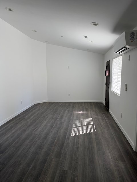 A room with a grey floor and a white wall.