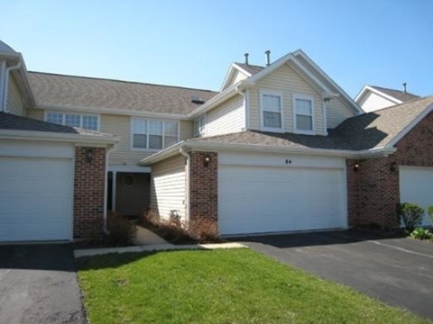 A house with a white garage door is shown.
