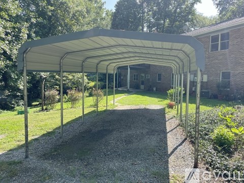 A covered walkway leads to a brick building.