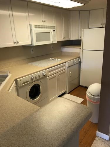 A white oven and microwave in a kitchen.