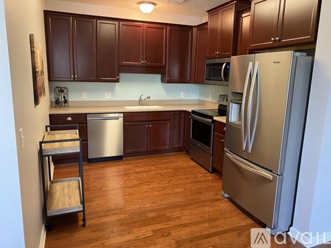 A kitchen with wooden cabinets and stainless steel appliances.
