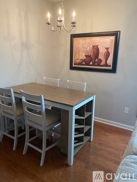 A dining room with a wooden table and chairs.