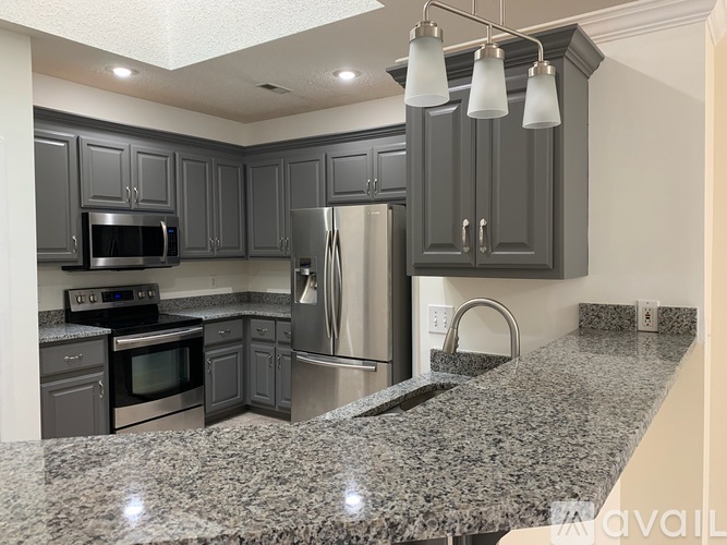 A kitchen with granite countertops and stainless steel appliances.