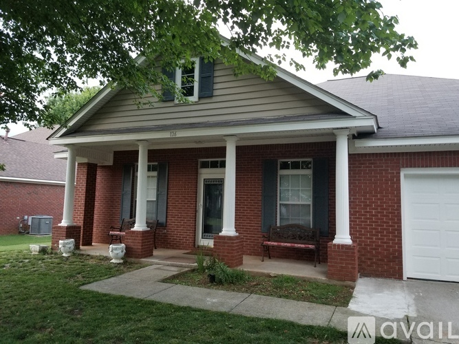 A house with a porch and a white garage door.