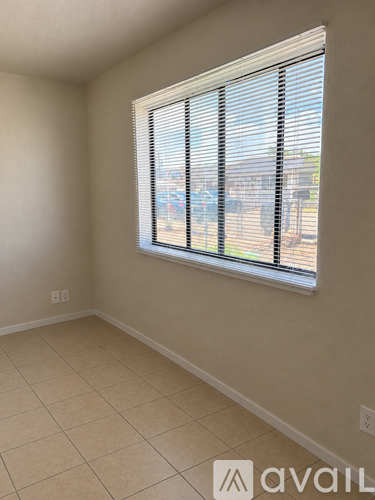 A kitchen with a trash bin in the middle of the room.