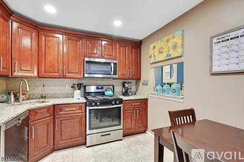A kitchen with brown cabinets and a white countertop.