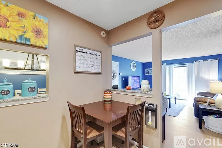 A dining room with a wooden table and chairs.
