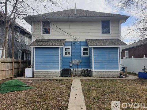 A two-story house with a blue garage door.