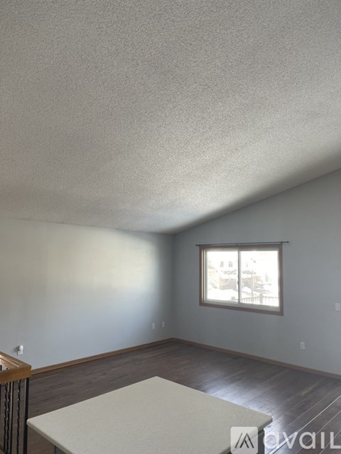 A room with a window and a table in it.
