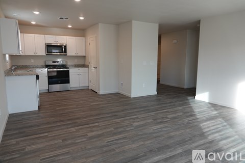 A kitchen with white cabinets and a microwave above the stove.