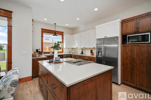 A kitchen with wooden cabinets and a white countertop.