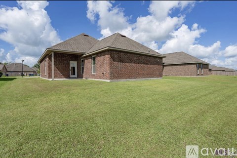 A house with a lawn in front of it.