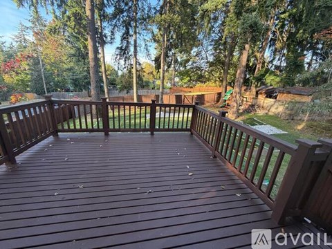 A wooden deck surrounded by trees.