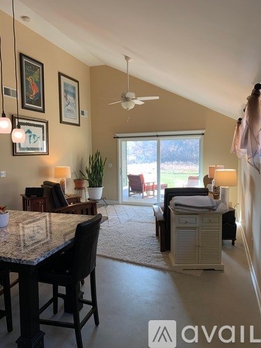 A living room with a dining table and chairs.